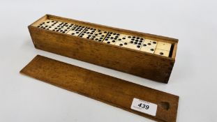 A COLLECTION OF VINTAGE EBONY AND BONE DOMINOES IN WOODEN BOX.