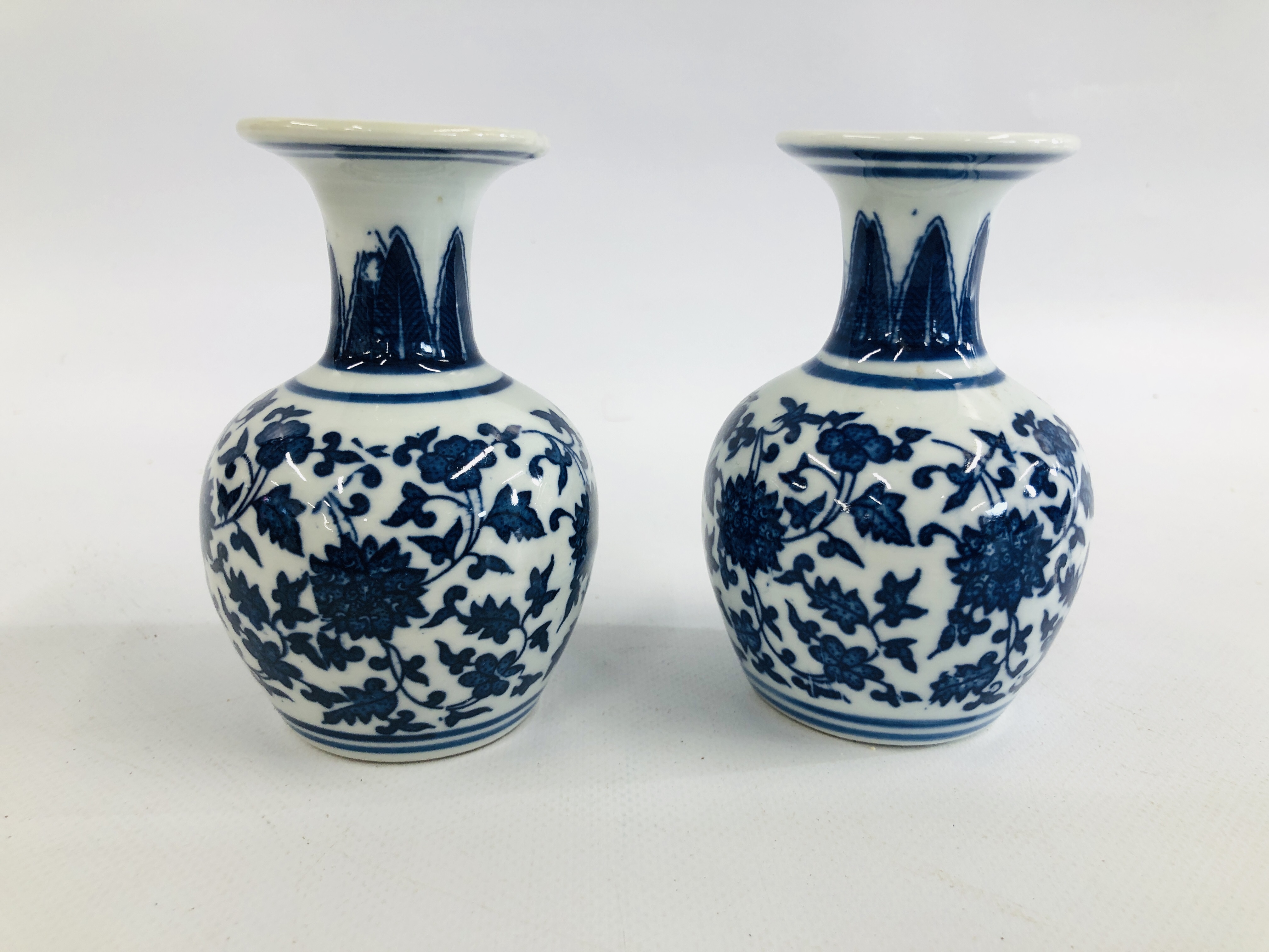 A PAIR OF CHINESE BLUE AND WHITE VASES OF BALUSTER FORM WITH FLARED RIMS BEARING "KANXI" SEAL MARK,