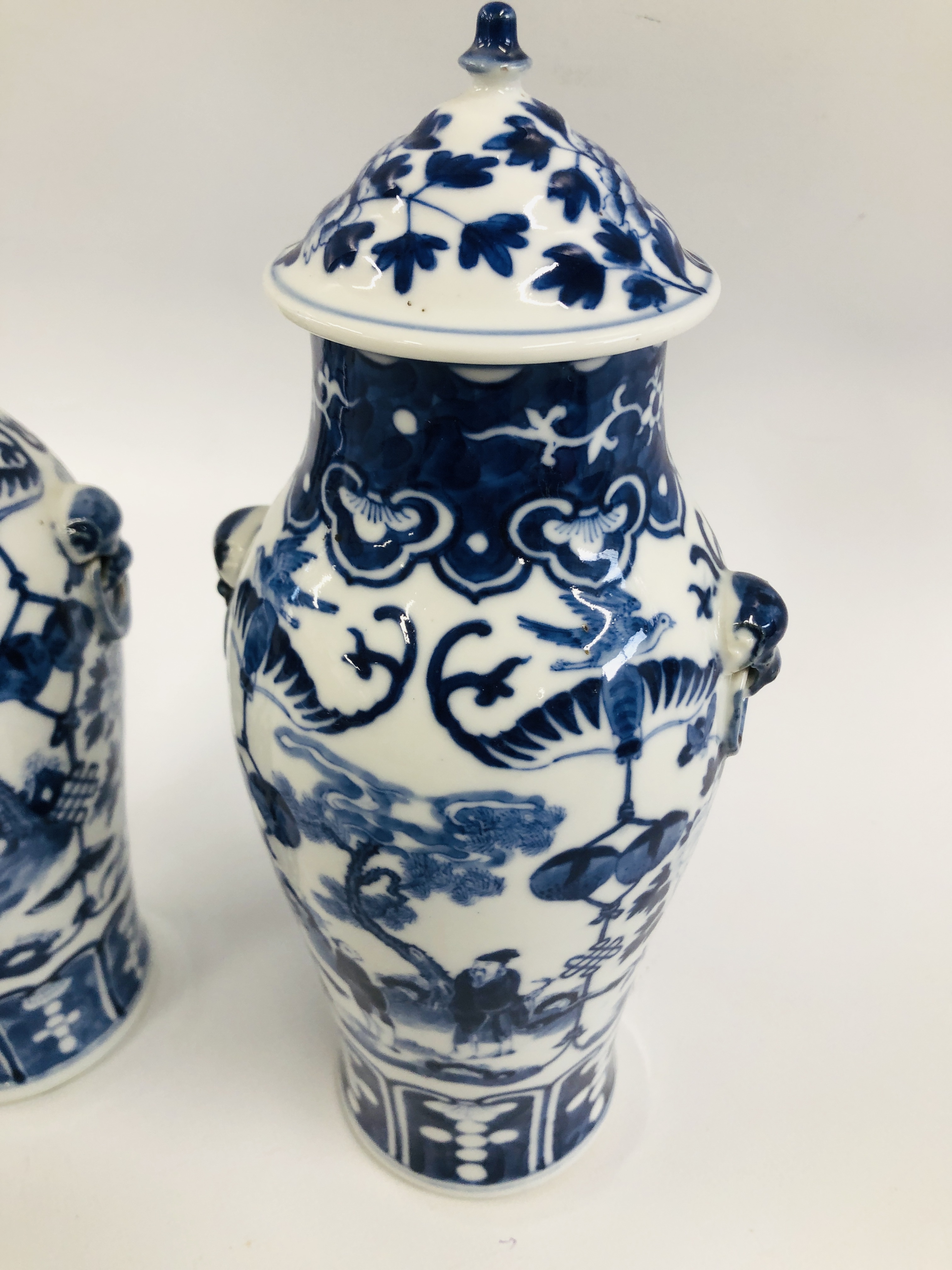 A PAIR OF ORIENTAL BLUE AND WHITE LIDDED URNS, DECORATED WITH FIGURES AND BLOSSOM, - Image 2 of 10