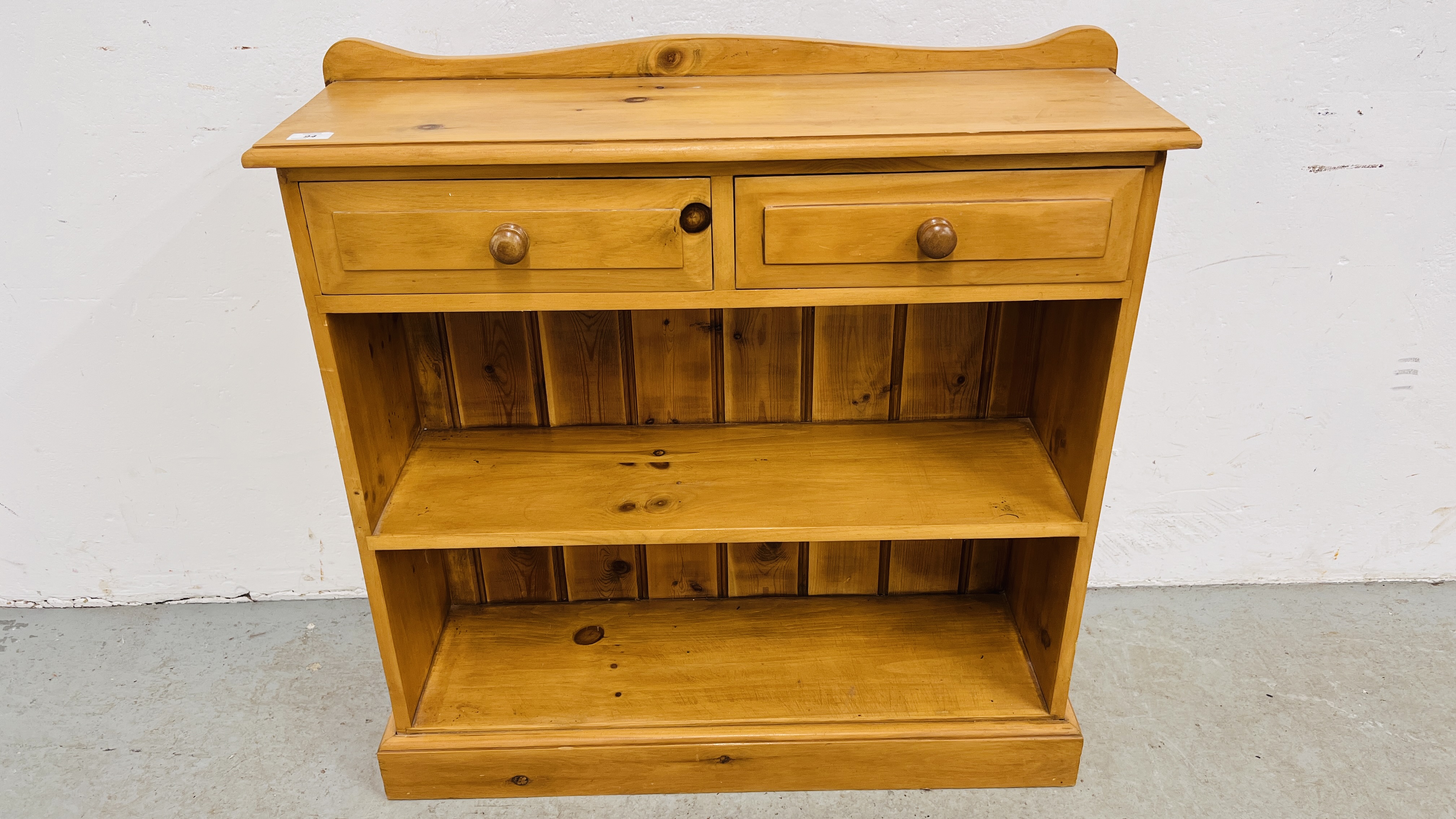 A WAXED PINE TWO TIER BOOKSHELF WITH DRAWERS, W 87CM, D 27CM, H 88CM.