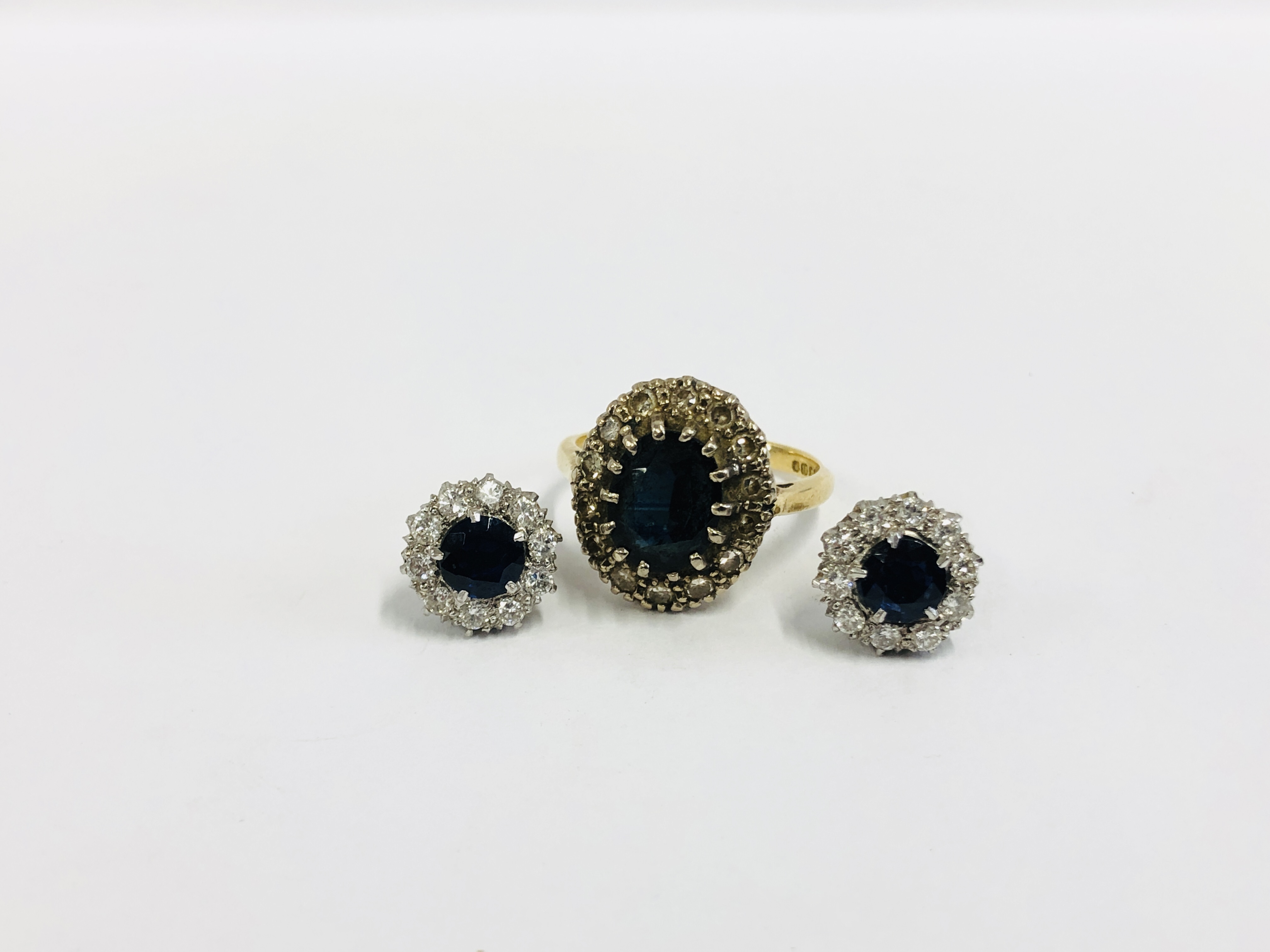 A PAIR OF WHITE METAL DIAMOND AND SAPPHIRE SET EARRINGS,