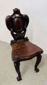 AN ANTIQUE MAHOGANY HALL CHAIR WITH ELABORATE CARVING 97CM. H.