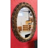 A C19TH GILT OVAL WALL MIRROR, 110CM HIGH.