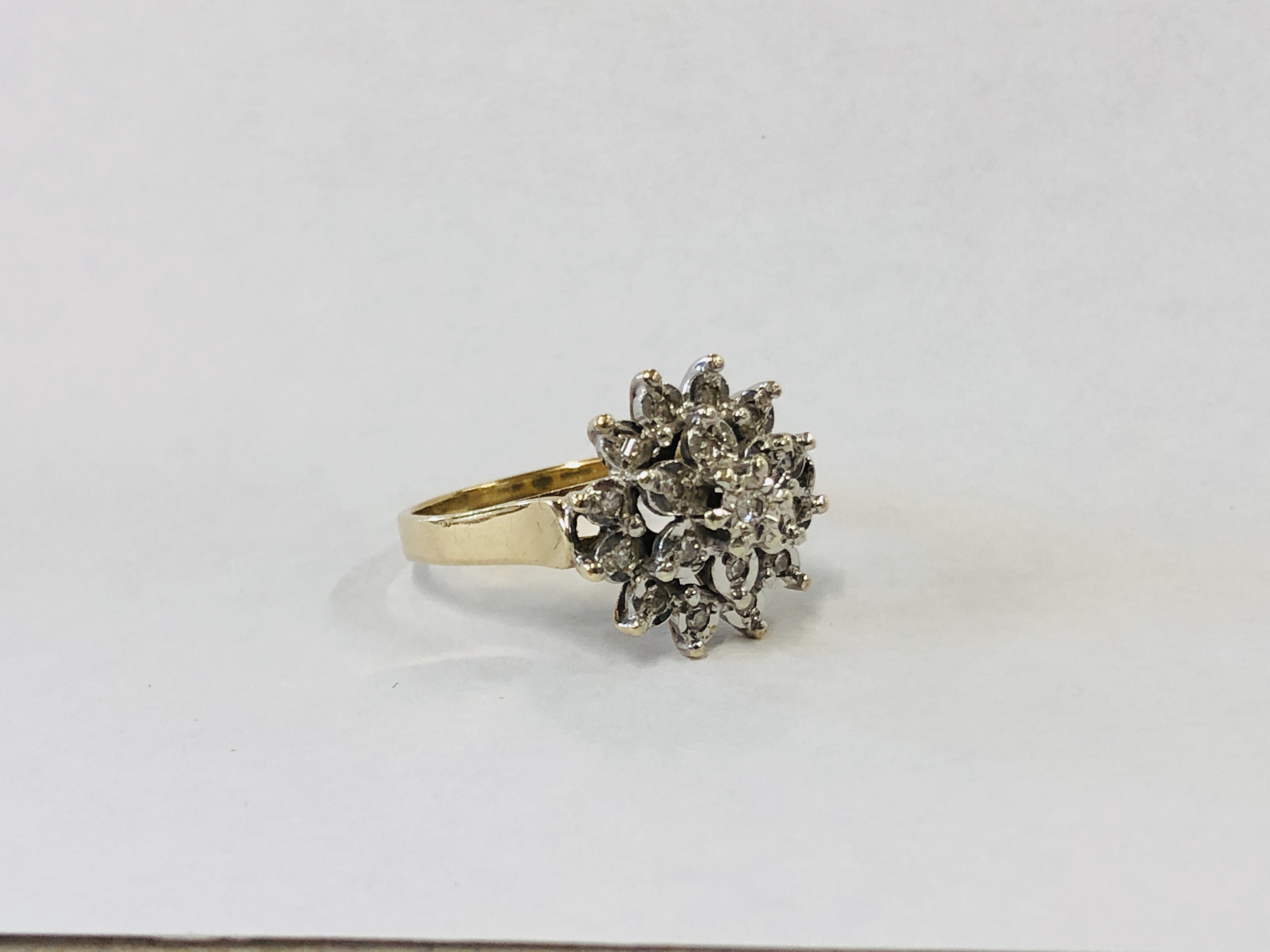 A 9CT GOLD DIAMOND CLUSTER RING