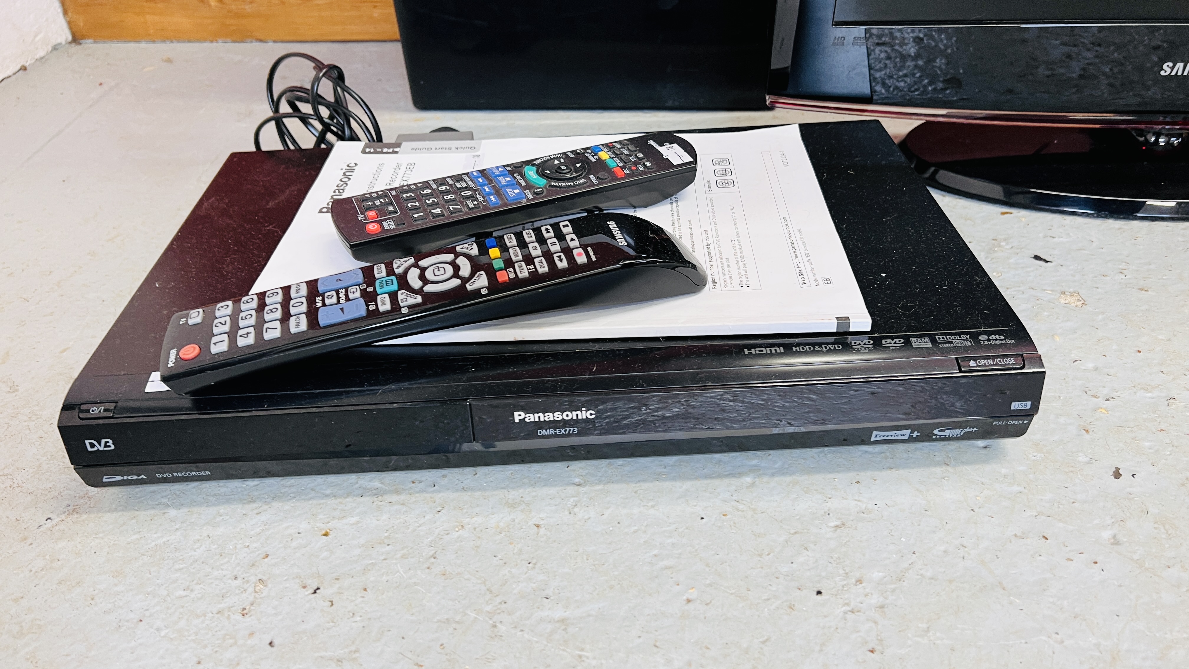 A SAMSUNG 22 INCH TELEVISION AND PANASONIC DVD RECORDER BOTH WITH REMOTES PLUS AN OFFICE PAPER - Image 3 of 4