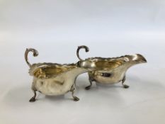 PAIR OF SILVER SAUCE BOATS WITH OPEN SCROLL HANDLE ON TRIPOD HOOF FEET LONDON 1912 LENGTH 16CM.