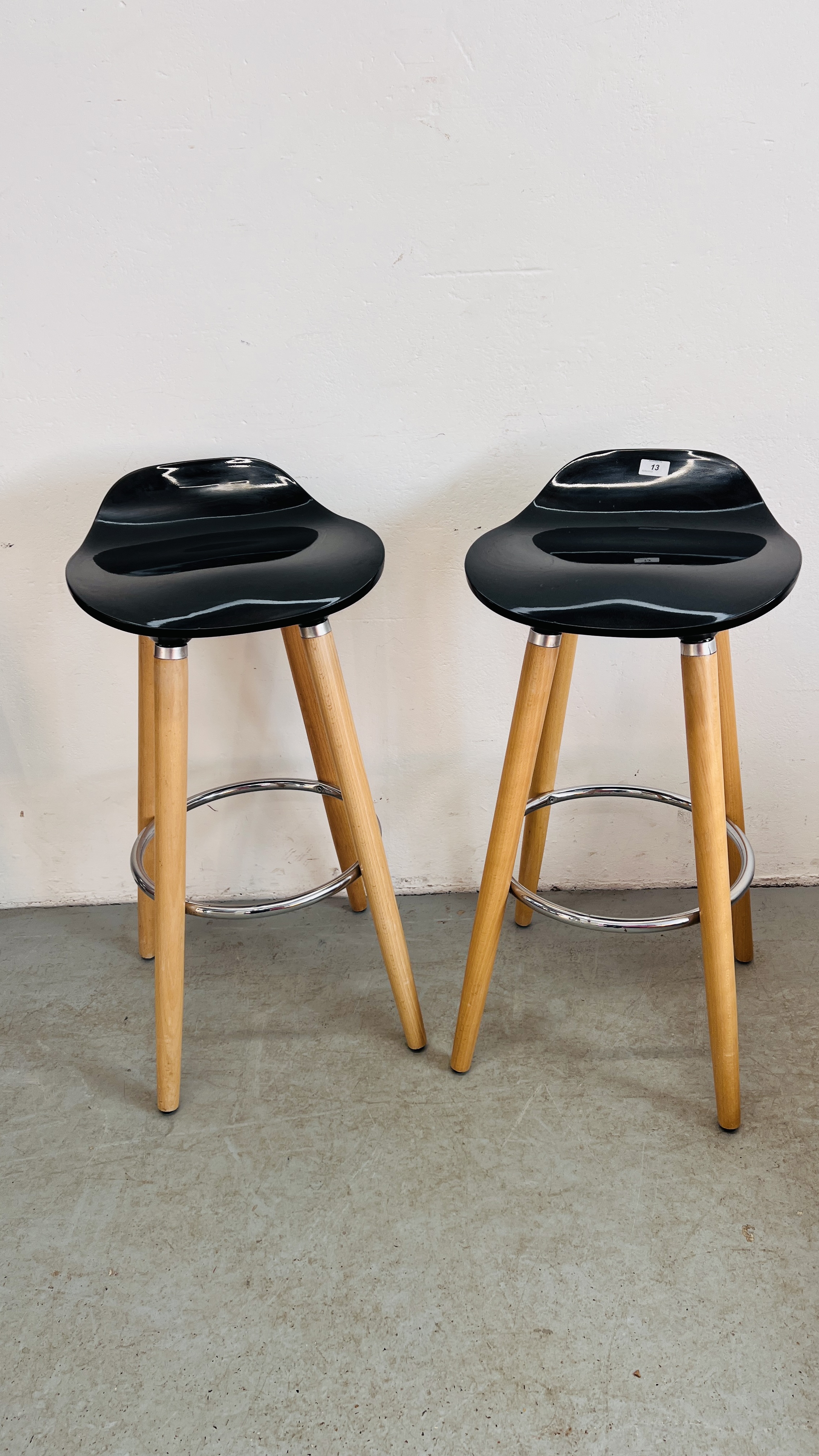 A PAIR OF PINE AND BLACK BREAKFAST BAR STOOLS.