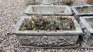 A PAIR OF HEAVY RECTANGULAR STONEWORK PLANTING TROUGHS WITH RELIEF CHERUB DECORATION. W 88CM.