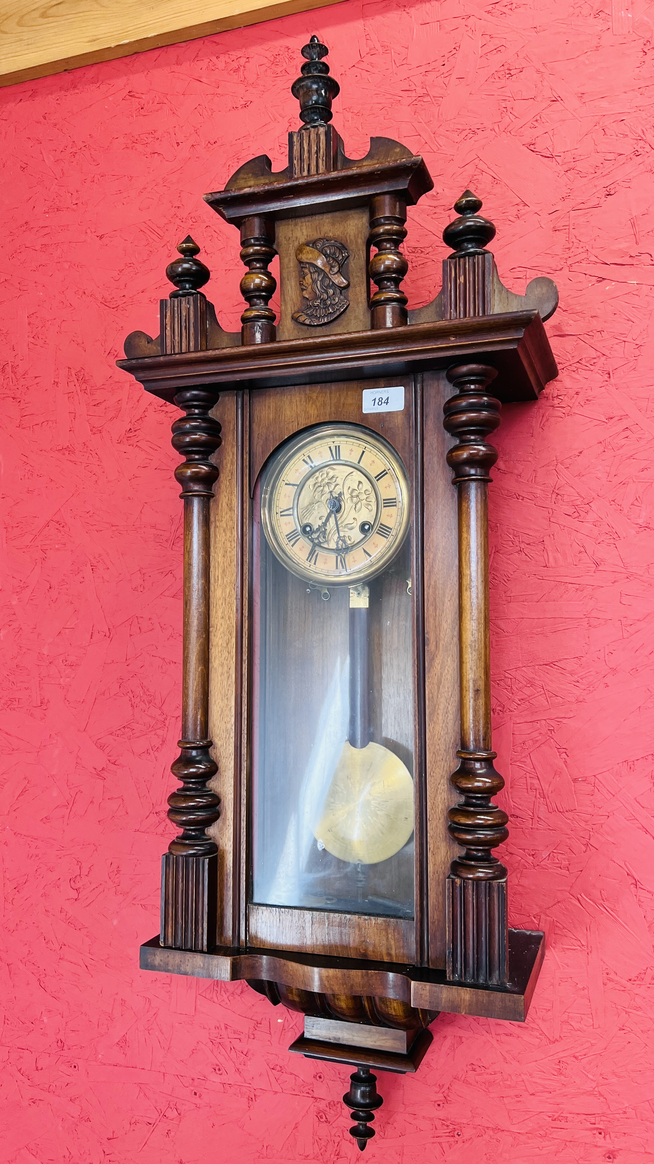 A MAHOGANY CASE VIENNA WALL CLOCK WITH KEY AND PENDULUM.