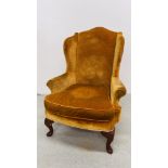 A MAHOGANY WINGED ARMCHAIR (COVER STAINED)