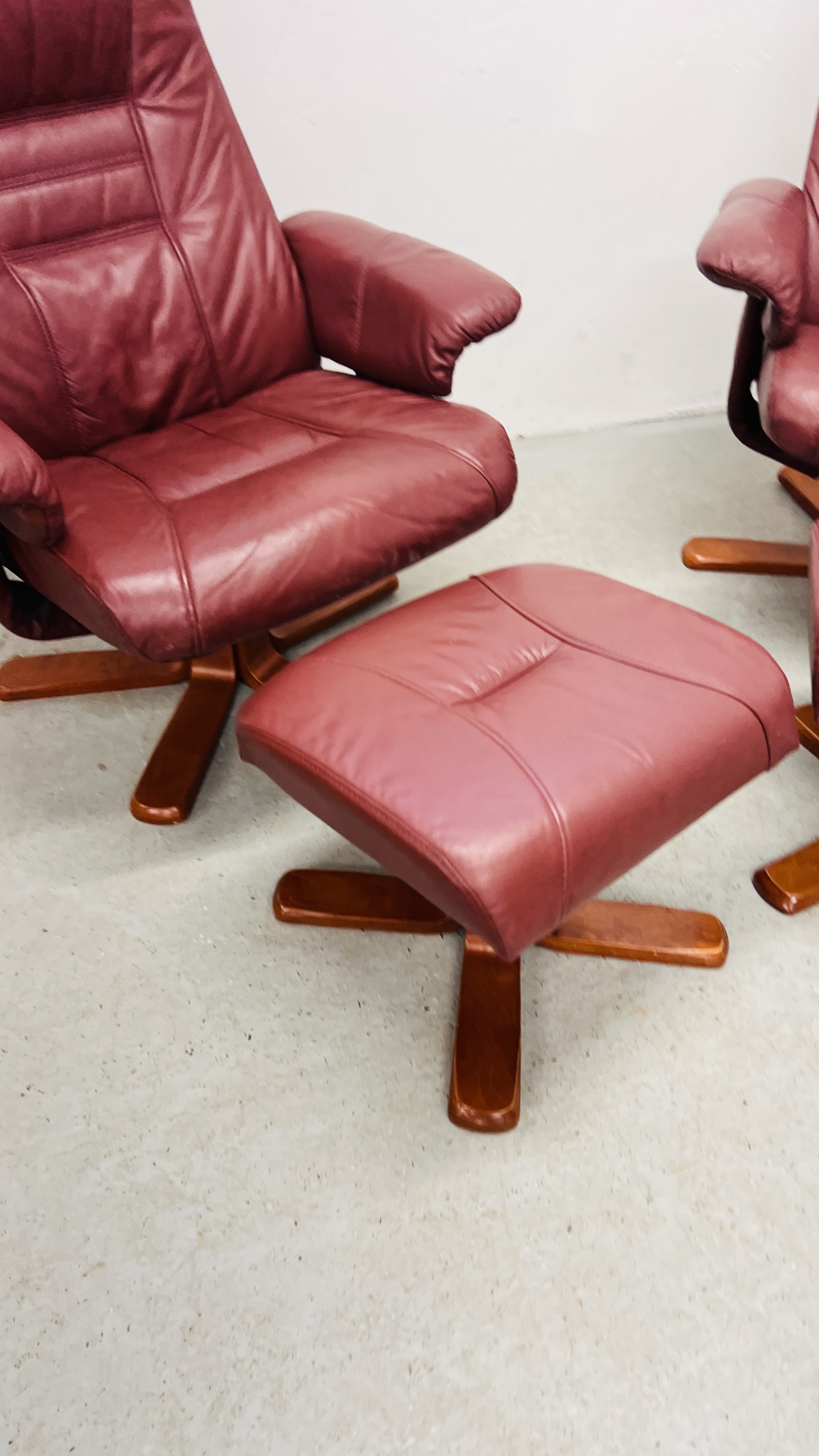 A PAIR OF RED LEATHER REVOLVING ARMCHAIRS WITH FOOTSTOOLS. - Image 3 of 25