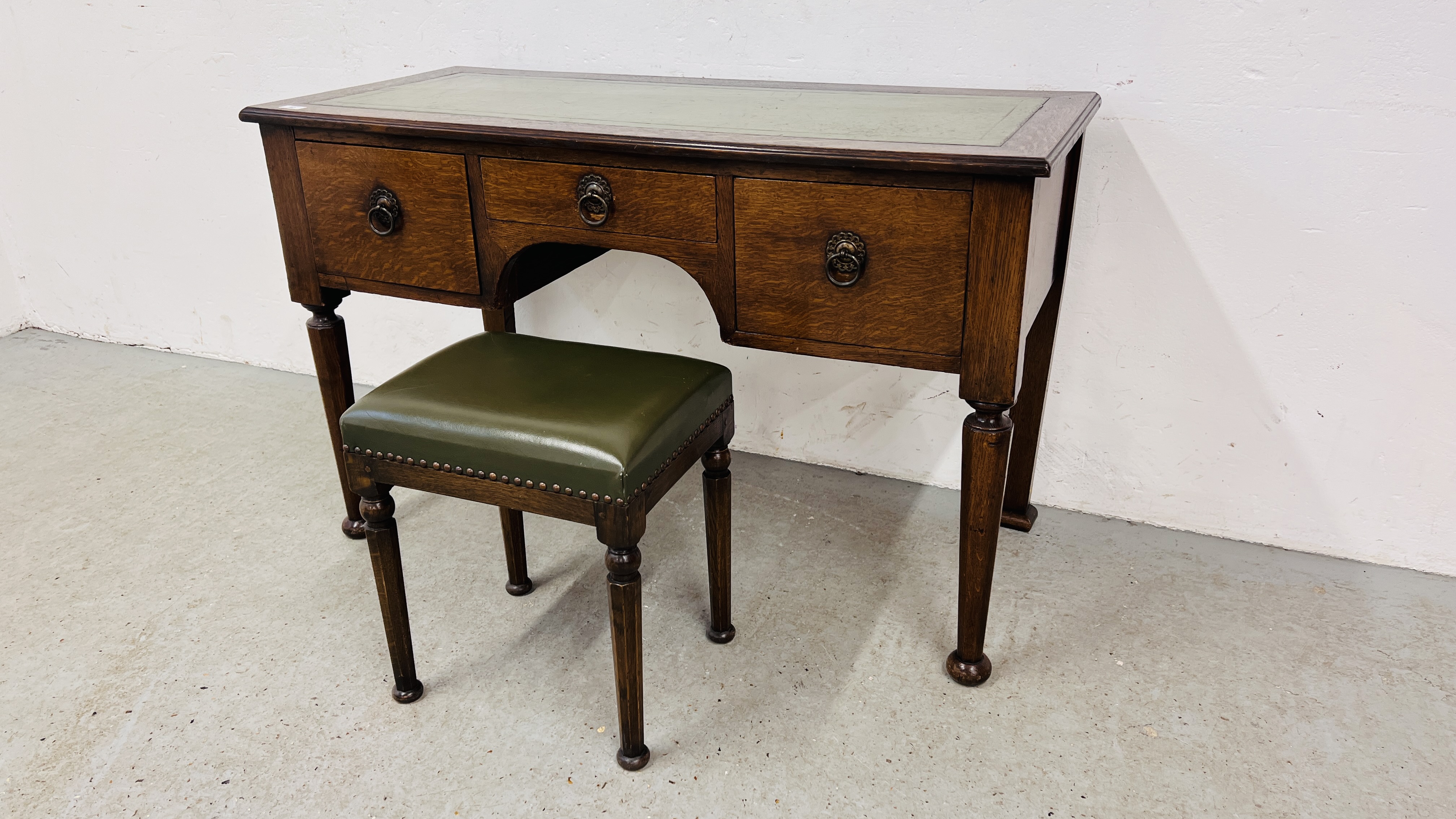 A SOLID OAK THREE DRAWER WRITING DESK WITH GREEN TOOLED LEATHERETTE WRITING SURFACE, W 120CM,