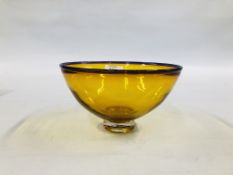 AN AMBER COLOURED ART GLASS STUDIO BOWL WITH A PURPLE RIM BEARING INDISTINCT SIGNATURE TO BASE.