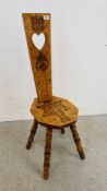 A DECORATIVE SPINNING CHAIR WITH POCKET DETAILING.