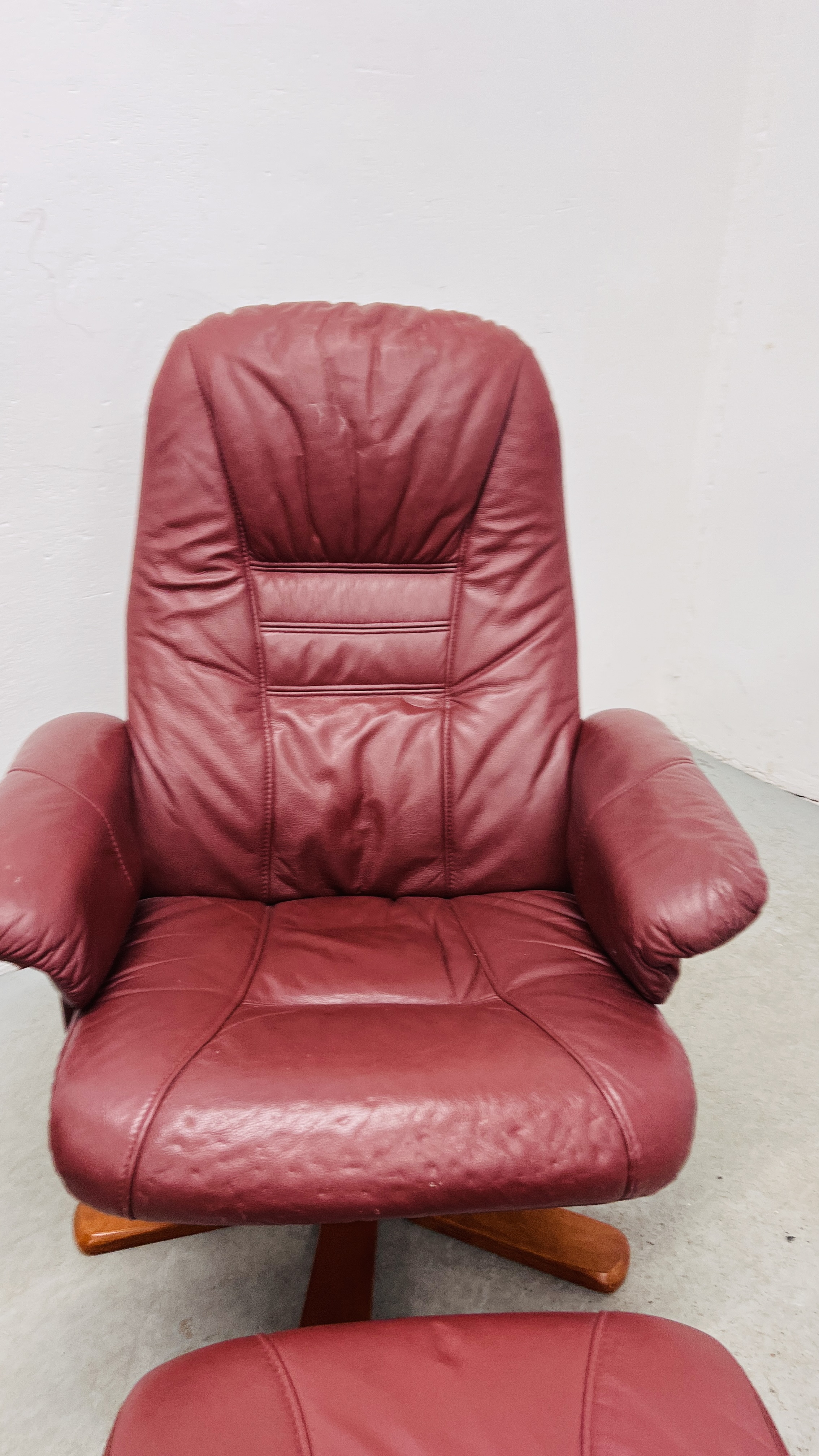 A PAIR OF RED LEATHER REVOLVING ARMCHAIRS WITH FOOTSTOOLS. - Image 10 of 25