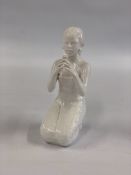 A SWEDISH PORCELAIN FIGURE OF A KNEELING GIRL, 24.5CM.