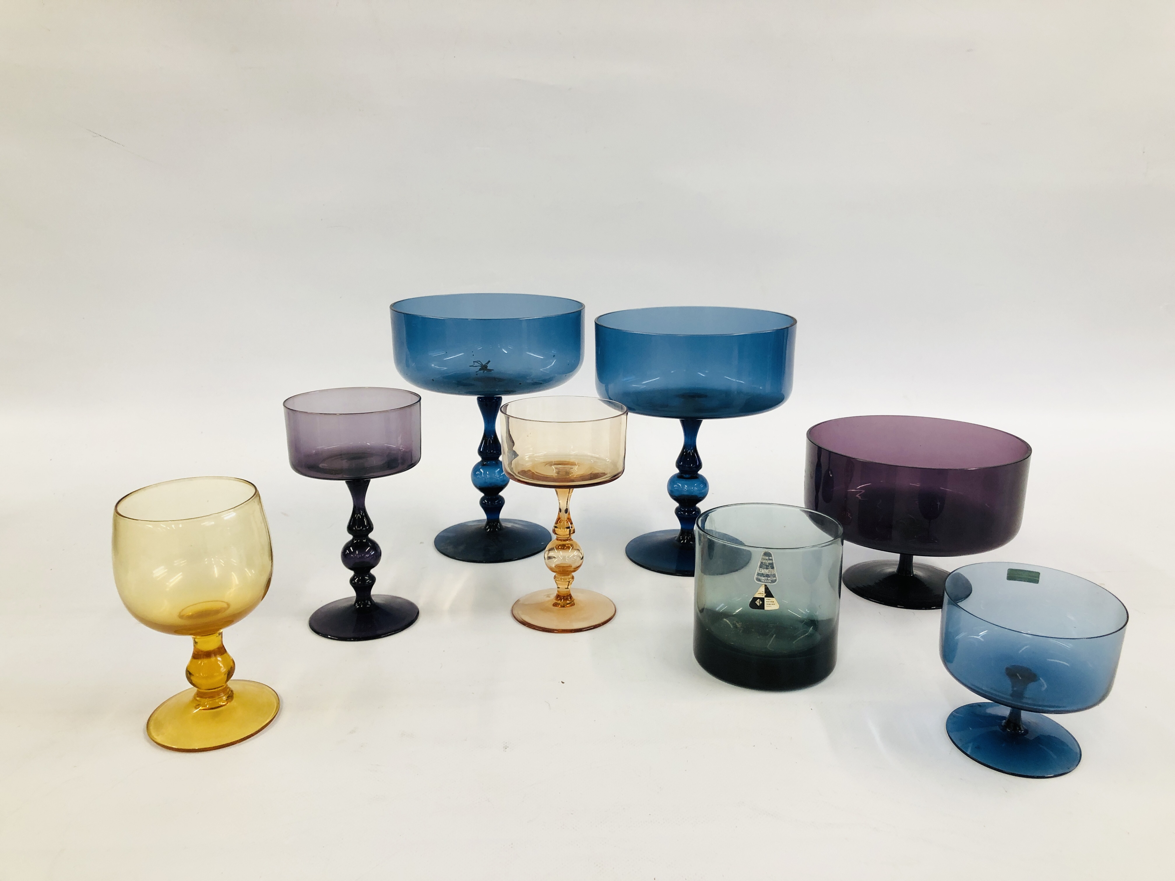 A GROUP OF MAINLY WEDGWOOD DESIGNER COLOURED GLASS INCLUDING TWO BLUE STEM CENTRE PIECE DESIGNED BY
