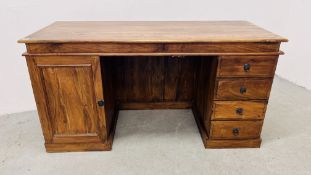 AN ORIENTAL HARDWOOD FOUR DRAWER DESK WITH SINGLE CUPBOARD 150CM. WIDE.