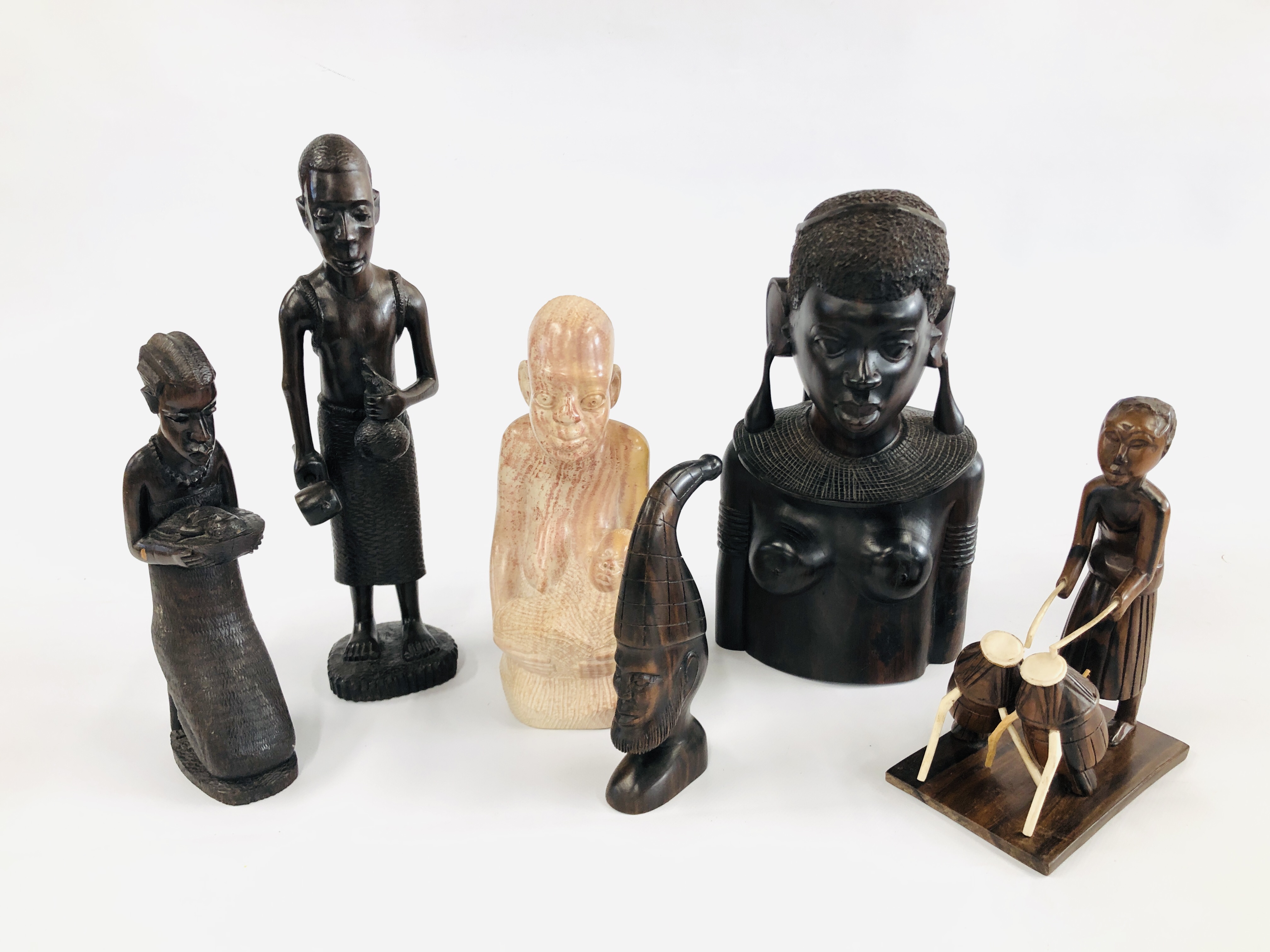 A HARD WOOD AFRICAN TRIBAL BUST ALONG WITH A FURTHER TWO FIGURES ONE OF WHICH IS HOLDING A NEW BORN