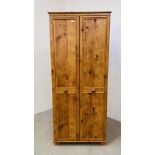 A PINE EFFECT DOUBLE DOOR WARDROBE.