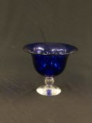 AN IMPRESSIVE BLUE STUDIO GLASS DISH ON CLEAR PEDESTAL BASE BEARING SIGNATURE DAVID WALLACE - H