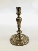 A CONTINENTAL CAST SILVER CANDLESTICK, THE GADROONED COLUMN ON A STEPPED AND SCROLLED BASE - 21.