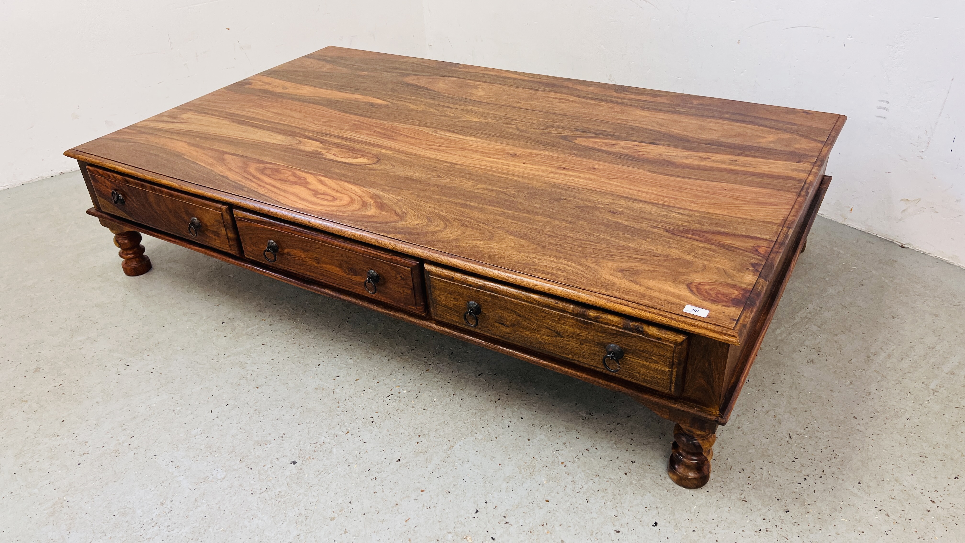 A MODERN ORIENTAL HARDWOOD COFFEE TABLE WITH FRIEZE DRAWERS 181CM. LONG.