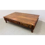 A MODERN ORIENTAL HARDWOOD COFFEE TABLE WITH FRIEZE DRAWERS 181CM. LONG.