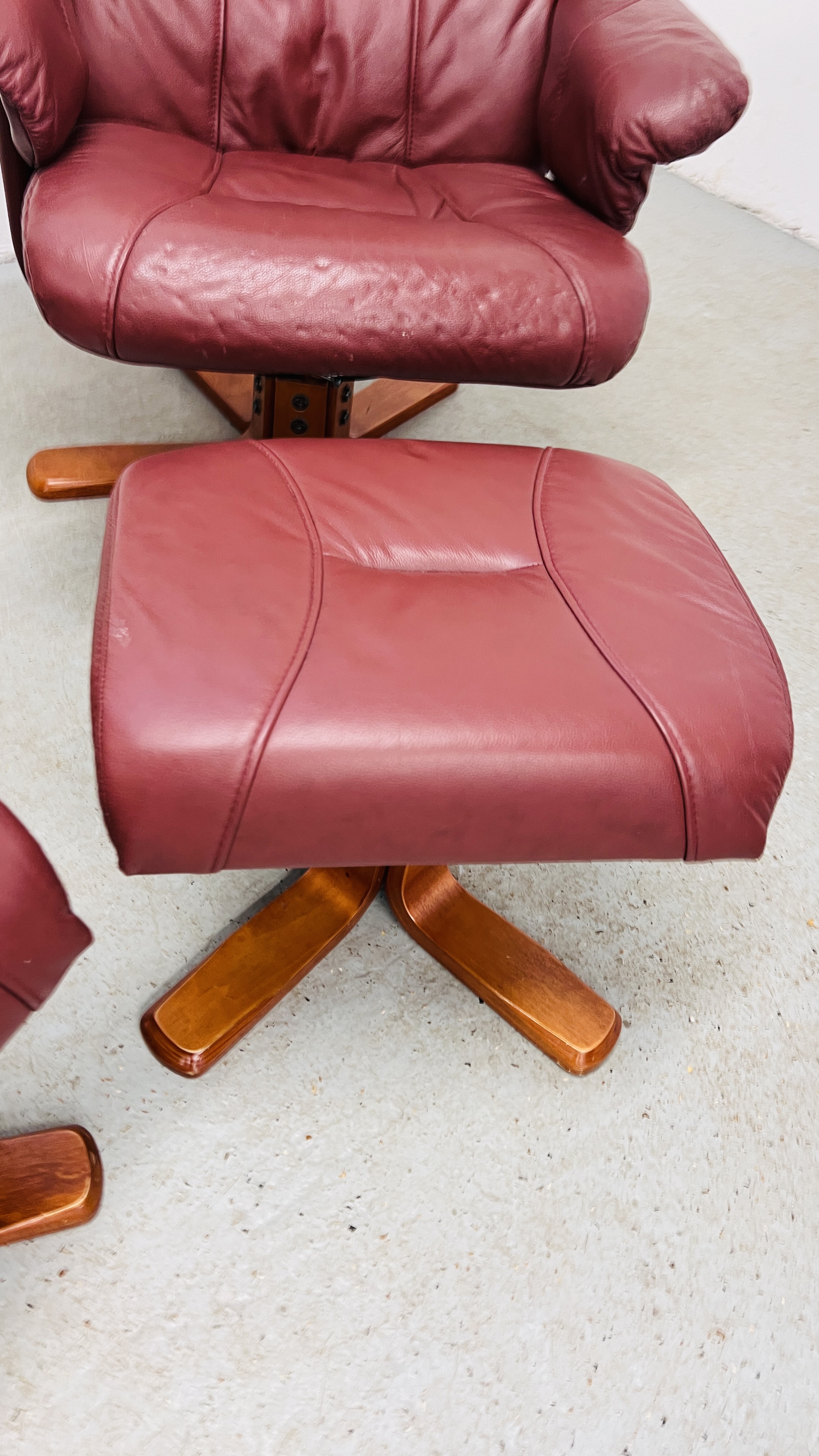 A PAIR OF RED LEATHER REVOLVING ARMCHAIRS WITH FOOTSTOOLS. - Image 9 of 25