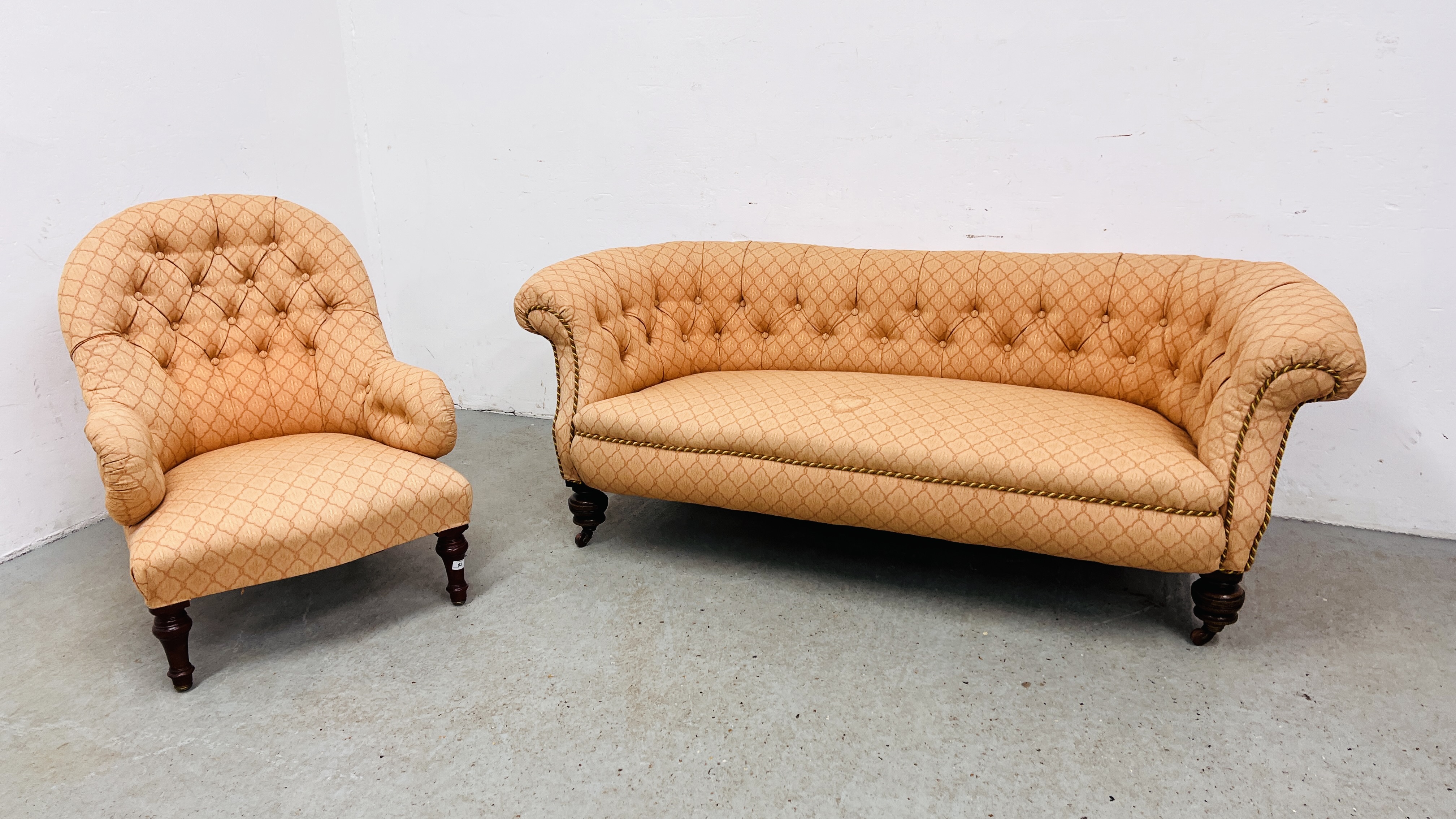 A VICTORIAN BUTTON BACK SOFA AND A LADY'S ARMCHAIR COVERED IN A SIMILAR FABRIC.