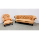 A VICTORIAN BUTTON BACK SOFA AND A LADY'S ARMCHAIR COVERED IN A SIMILAR FABRIC.