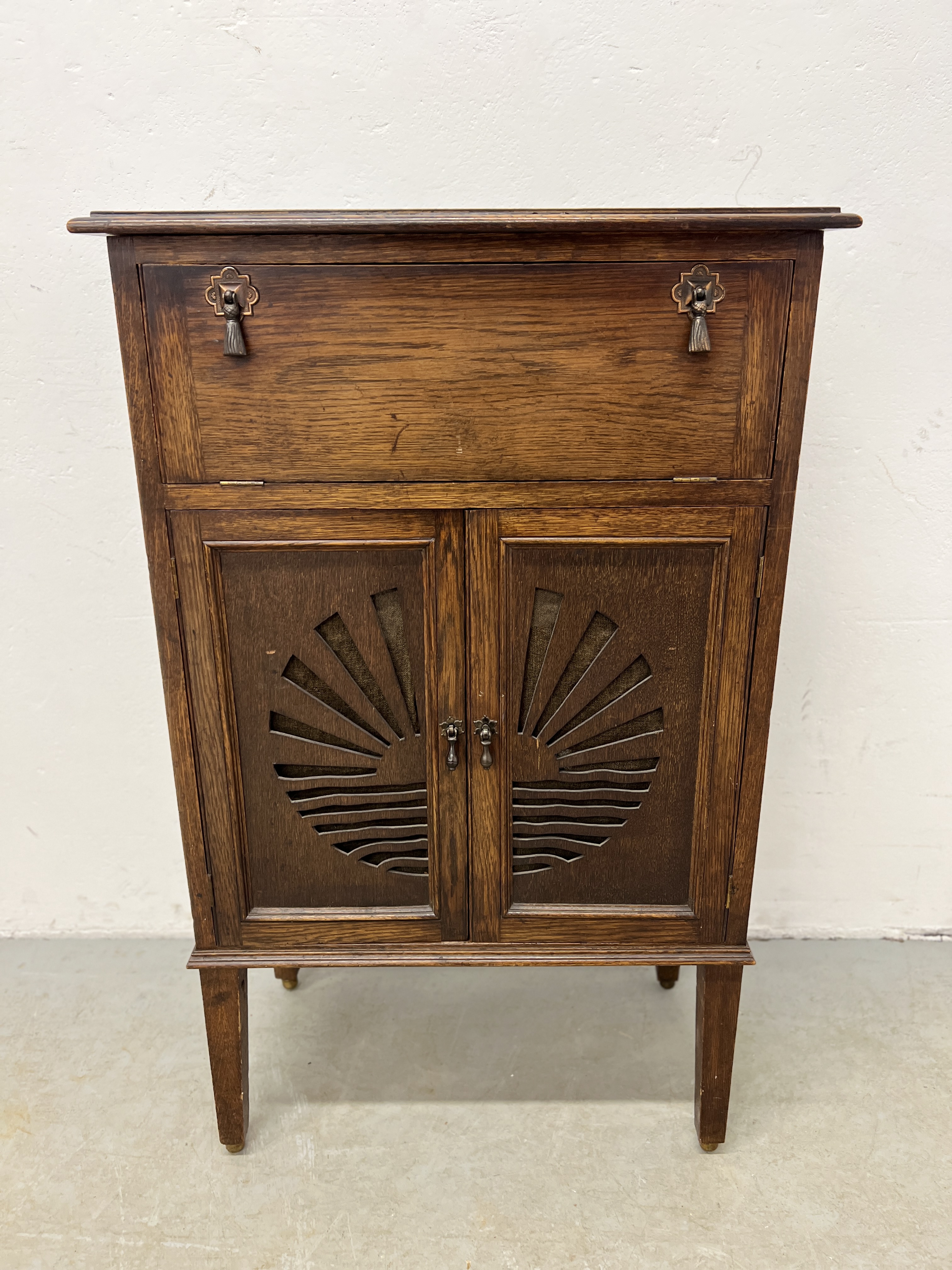 A 1930'S OAK SUNRISE DETAILED MUSIC CABINET 100CM. H X 62CM. W.