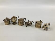 A GROUP OF SIX VARIOUS SILVER MUSTARDS ALL WITH HINGED COVERS AND LINERS VARIOUS ASSAY AND MAKERS.