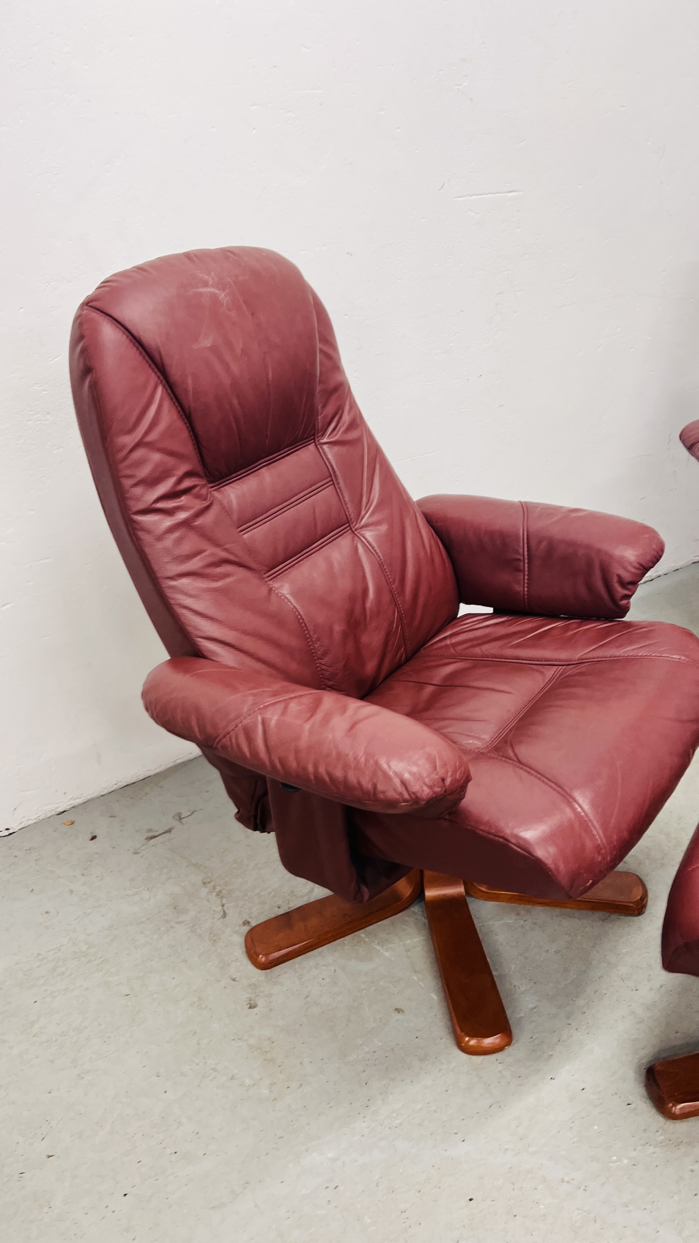 A PAIR OF RED LEATHER REVOLVING ARMCHAIRS WITH FOOTSTOOLS. - Image 4 of 25