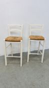 A PAIR OF WHITE PAINTED RUSH SEATED BAR STOOLS.