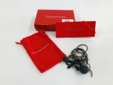 A FASHION ACCESSORY MARKED CHRISTIAN LACROIX IN ORIGINAL BOX.