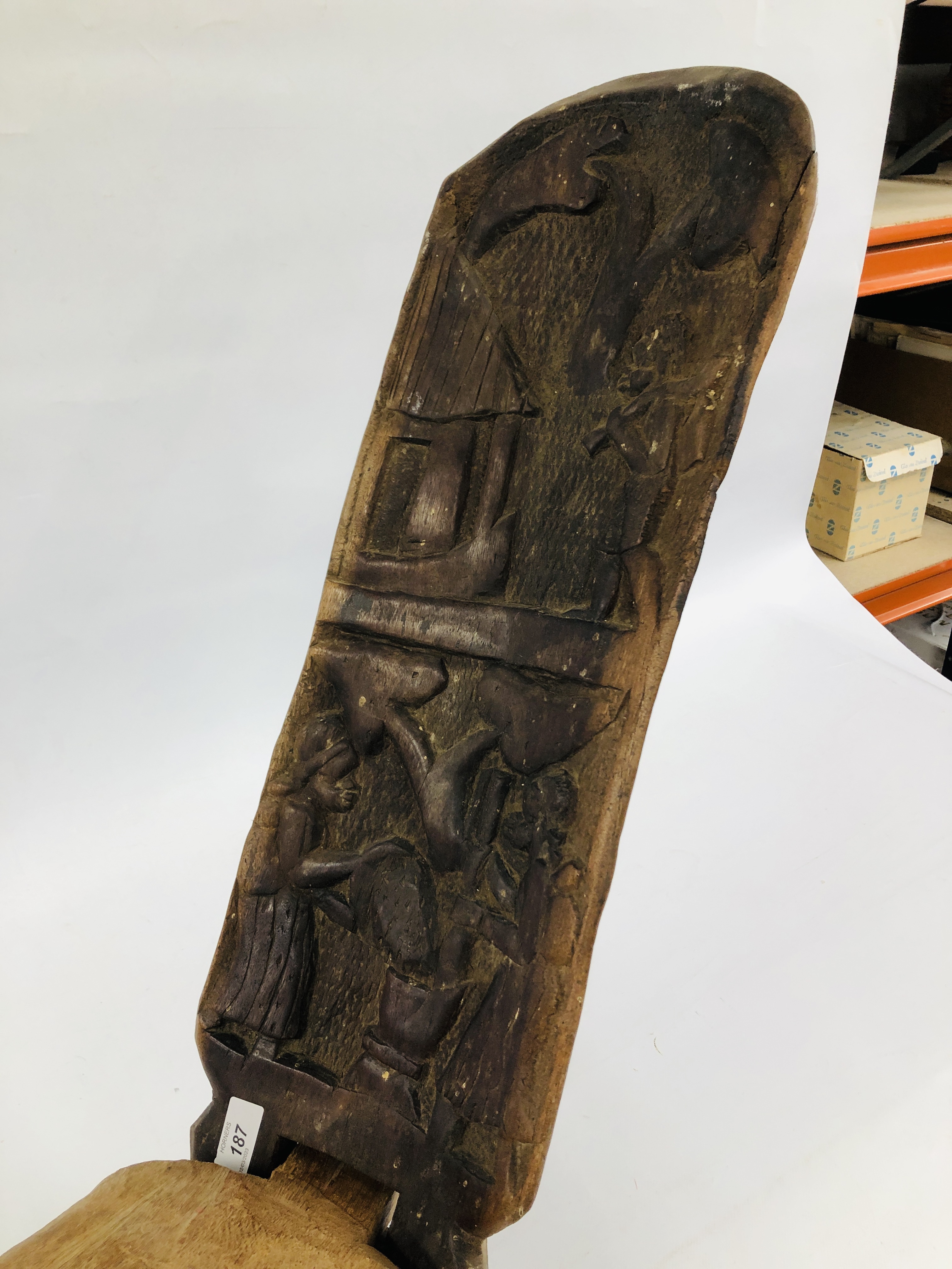 A VINTAGE HARDWOOD CARVED SELF SUPPORTING TRIBAL SEAT. - Image 2 of 4