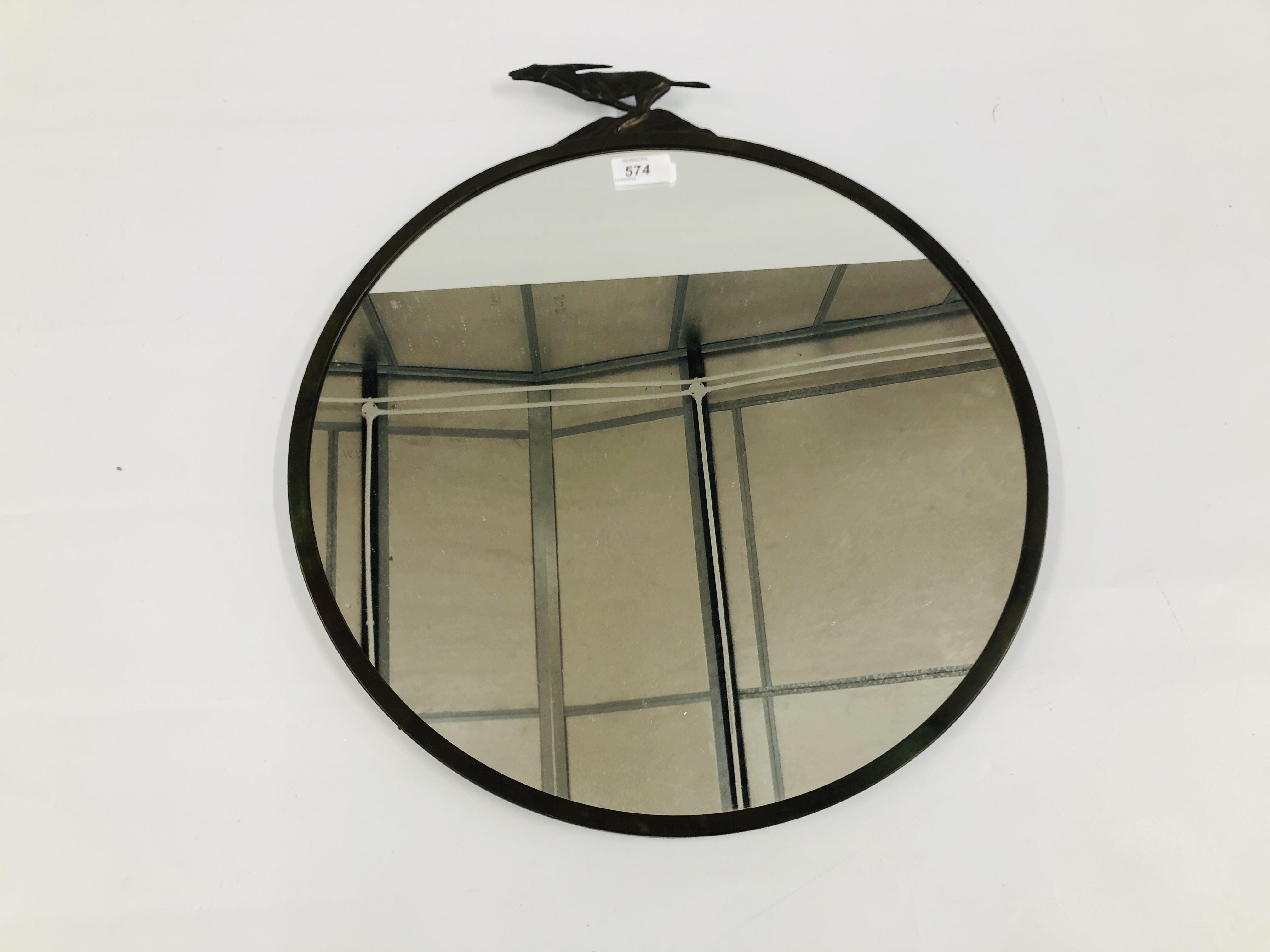 A VINTAGE BRONZED FINISH CIRCULAR WALL MIRROR, WITH A HARE MOTIF. DIAMETER 44.5CM.