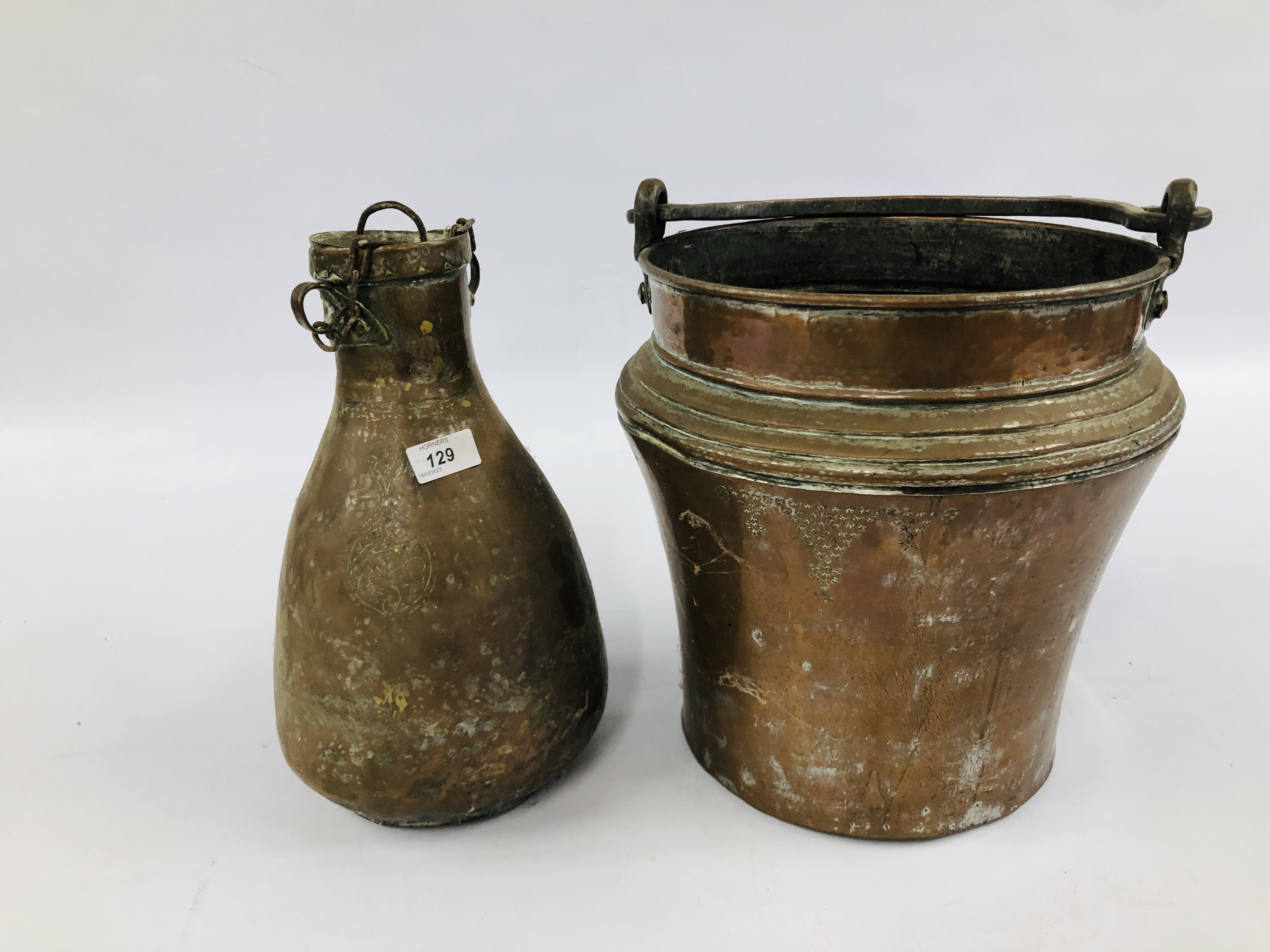 A LARGE MIDDLE EASTERN METAL WARE BUCKET, H 32CM AND SIMILAR WATER CARRIER, H 35CM.