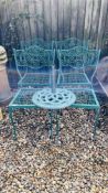 A SET OF FOUR GREEN METAL GARDEN CHAIRS AND CAST IRON PARASOL BASE AND A GARDEN TABLE WITH STONE