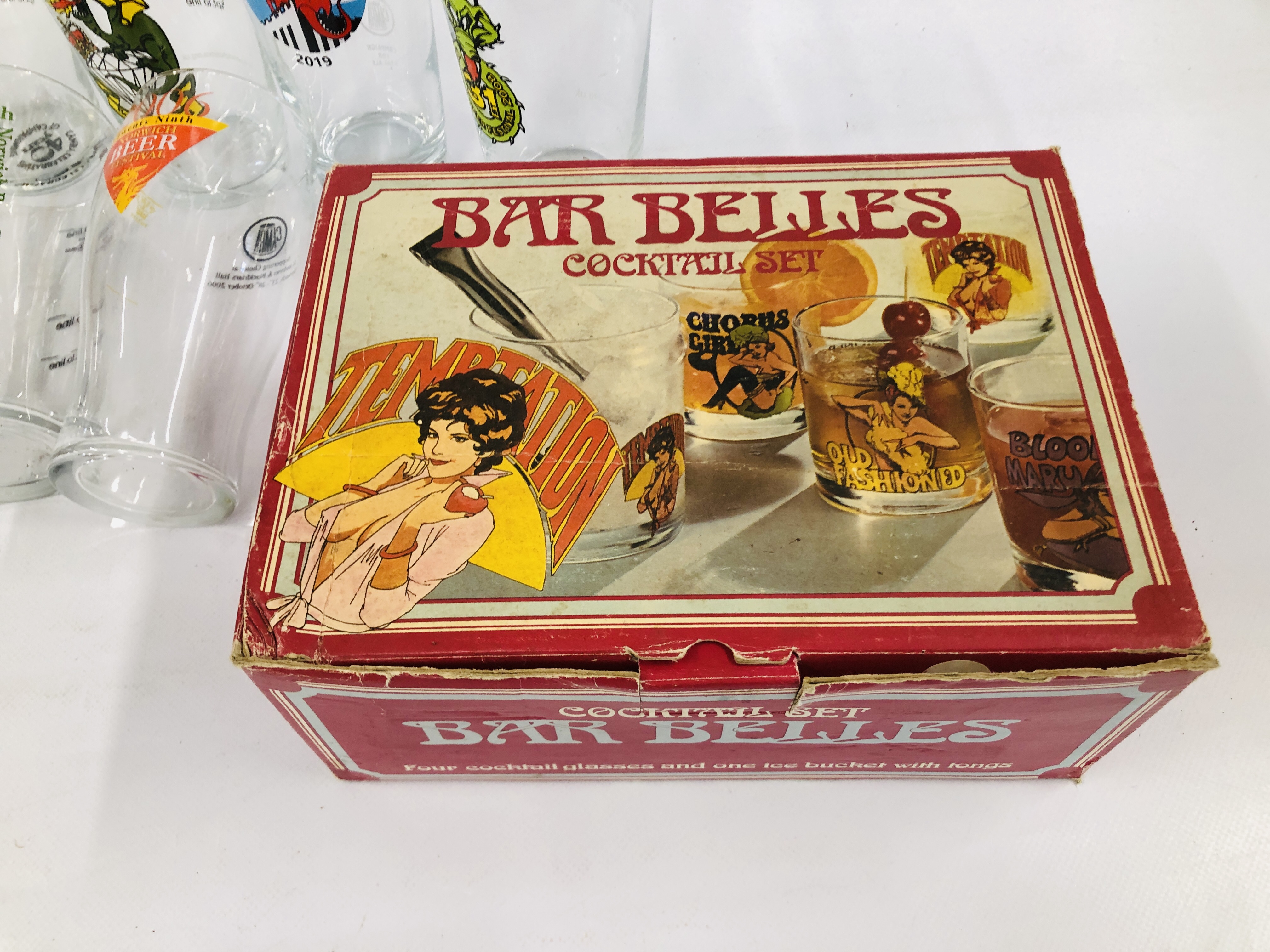 A COLLECTION OF 13 NORWICH BEER FESTIVAL GLASSES ALONG WITH A VINTAGE BOXED SET "BAR BELLES - Image 6 of 7