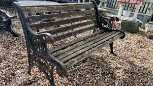 A GARDEN BENCH WITH SLATTED SEAT AND DECORATIVE CAST ENDS, LENGTH 127CM.