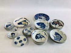 A GROUP OF CHINESE BLUE AND WHITE PLATES AND DISHES DECORATED WITH A FISH SYMBOL ALONG WITH A