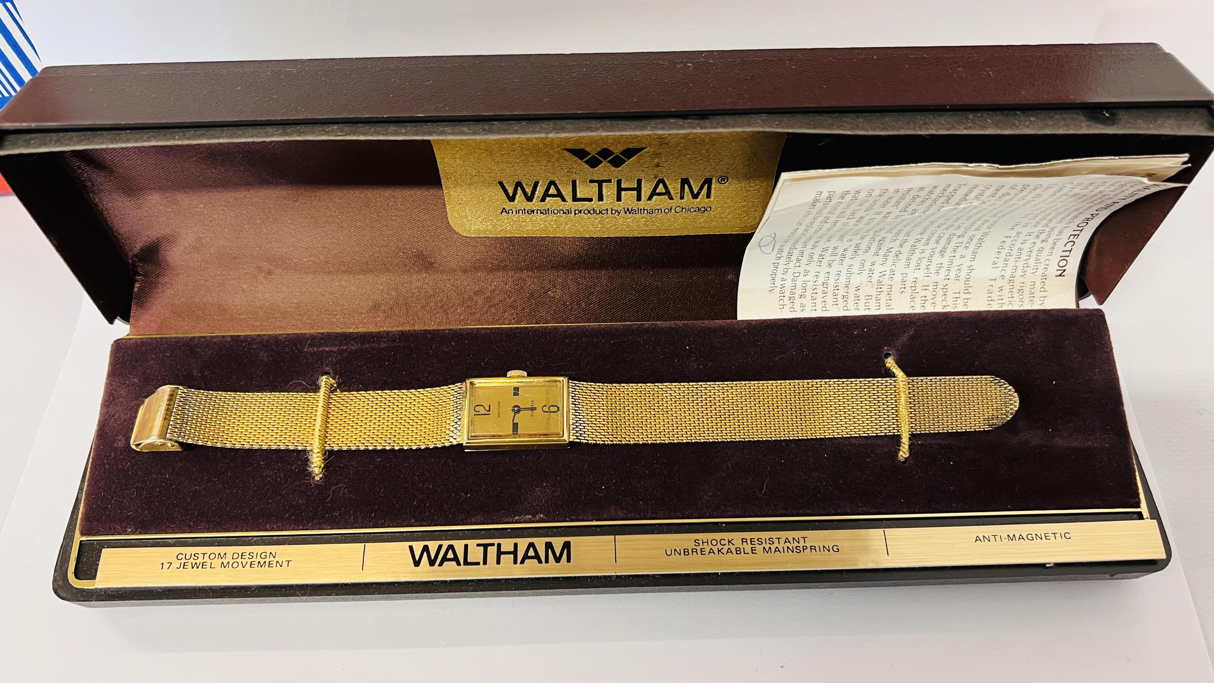 A VINTAGE GENT'S WRIST WATCH MARKED "WALTHAM" IN ORIGINAL BOX WITH WATCH OWNERS GUIDE.