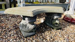 A STONEWORK GARDEN BENCH THE CURVED SEAT SUPPORTED BY DOLPHINS, LENGTH 110CM.