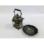 AN ORNATE METAL SPIRIT KETTLE COMPLETE WITH STAND AND BURNER ALONG WITH A SCOLLOPED EDGE PEWTER