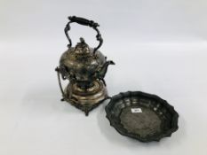 AN ORNATE METAL SPIRIT KETTLE COMPLETE WITH STAND AND BURNER ALONG WITH A SCOLLOPED EDGE PEWTER