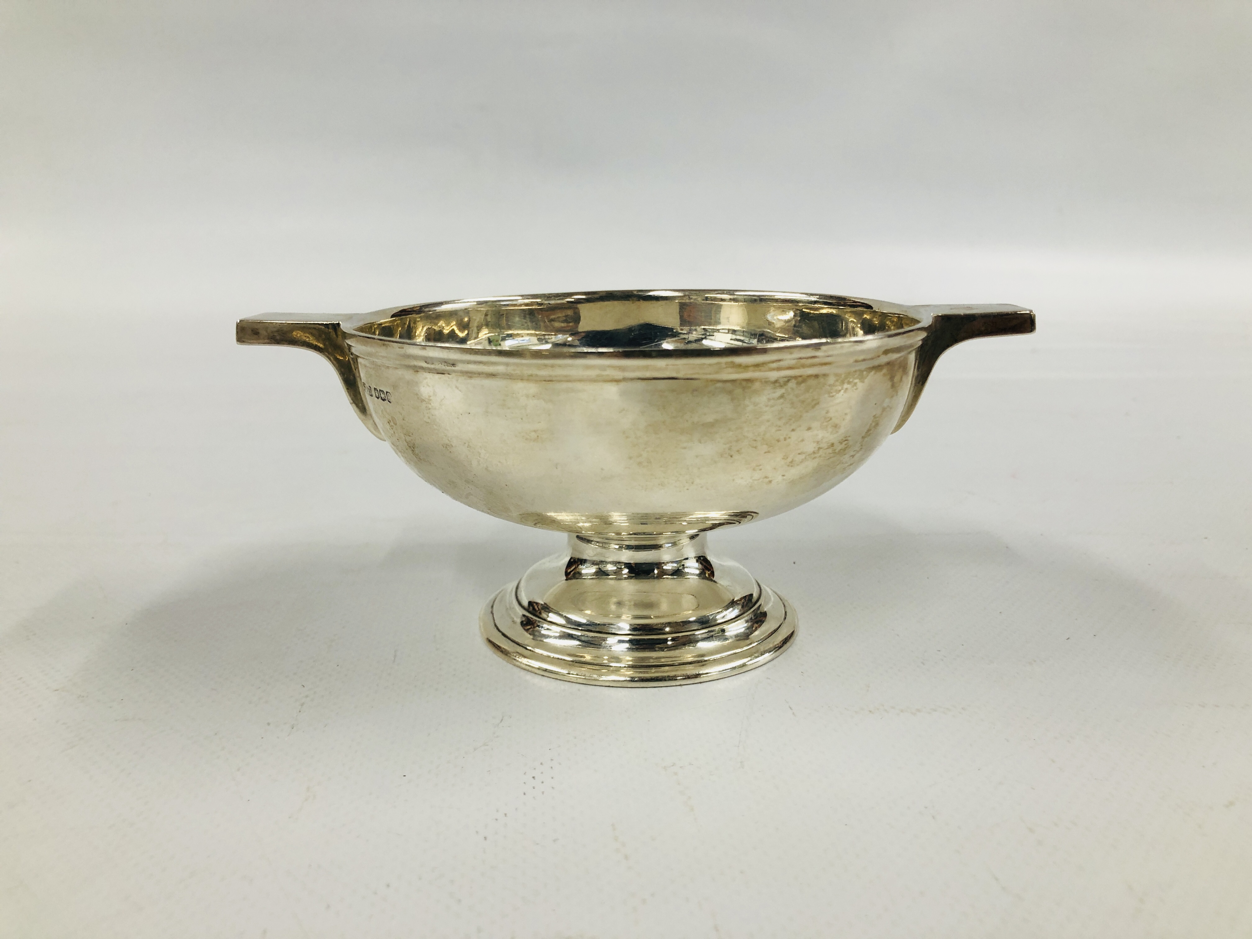 A SILVER FOOTED TWO HANDLED BOWL - BOWL DIAMETER 11.5CM.
