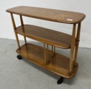 AN ERCOL WINDSOR GIRAFFE TROLLEY BOOKCASE W 91CM X D 31CM X H 75.5CM.