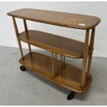 AN ERCOL WINDSOR GIRAFFE TROLLEY BOOKCASE W 91CM X D 31CM X H 75.5CM.